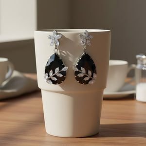 Rhodium-Plated Black Gemstone Teardrop Drop Earrings with American Diamond Leaf Accents