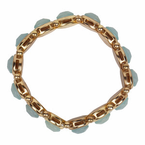 Chunky gold bracelet studded with big blue stones